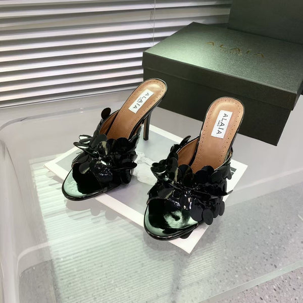 Mules in pelle Alaia Confetti in pelle di pecora nera lucida 293163