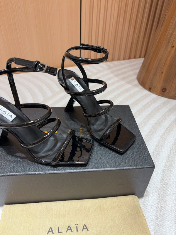 ALAIA THREE-STRAPS HIGH HEEL SANDALS IN BLACK PATENT LAMBSKIN
