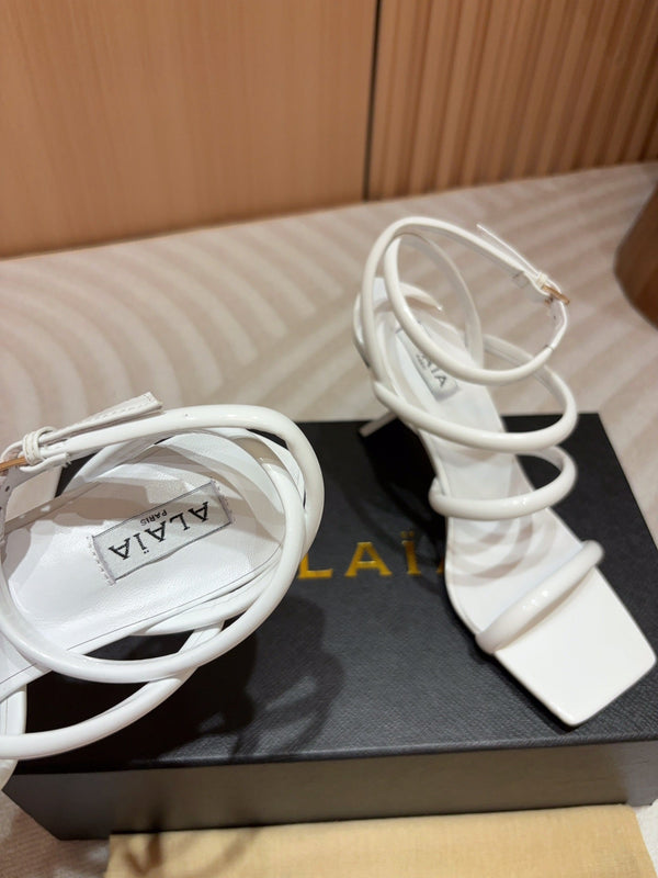 ALAIA THREE-STRAPS HIGH HEEL SANDALS IN WHITE PATENT LAMBSKIN