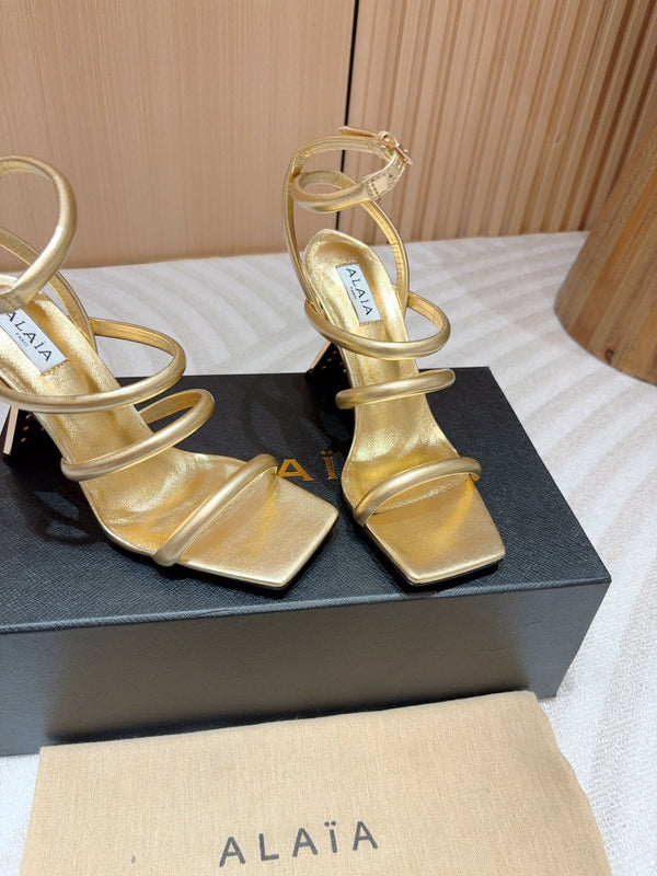 ALAIA THREE-STRAPS HIGH HEEL SANDALS IN GOLDEN PATENT LAMBSKIN