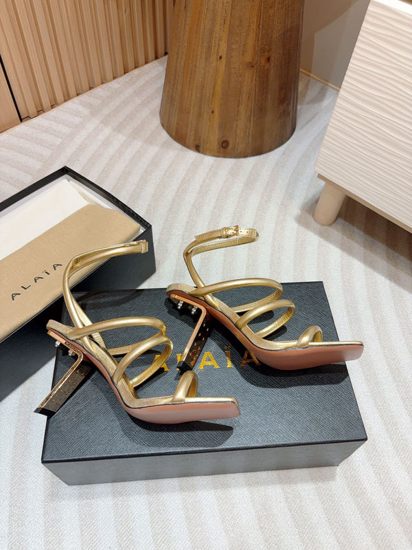 ALAIA THREE-STRAPS HIGH HEEL SANDALS IN GOLDEN PATENT LAMBSKIN