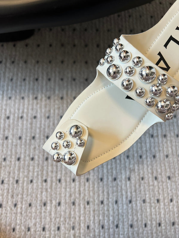 ALAIA FOLDED FLAT MULES WITH SPHERES ON WHITE CALFSKIN