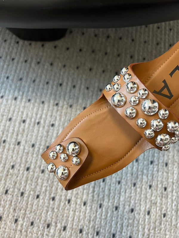 ALAIA FOLDED FLAT MULES WITH SPHERES ON COPPER BROWN CALFSKIN