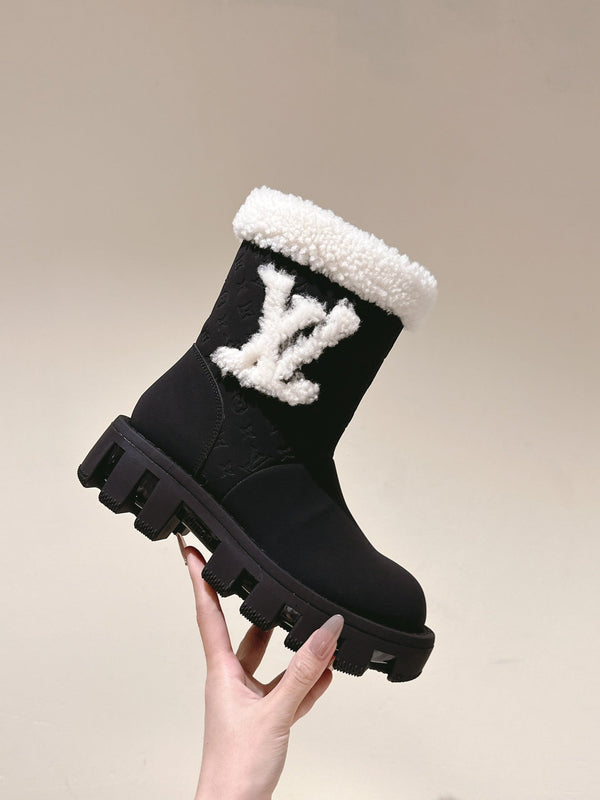 STIVALETTI IN PELLE DI VITELLO GOFFRATA NERA E SHEARLING BIANCO