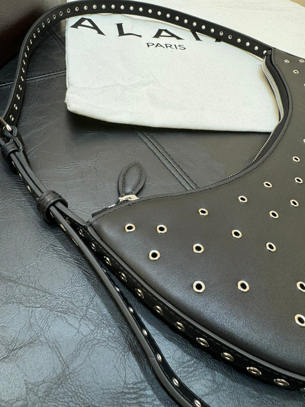 ONE PIECE DEMI LUNE BAG 31 IN BLACK SHEEPSKIN EYELET DETAILING
