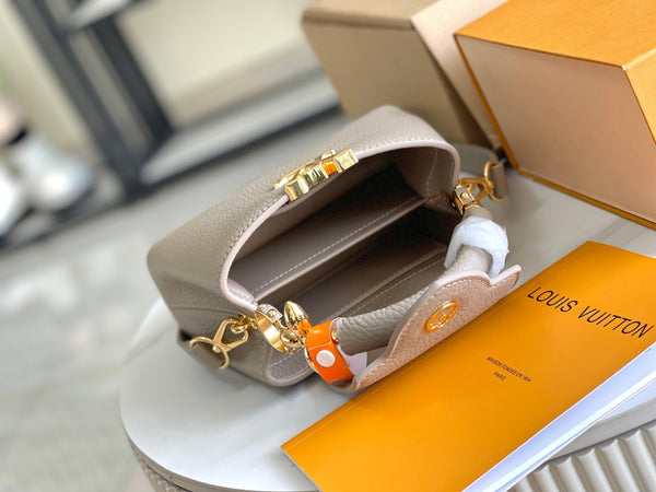 CAPUCINES MINI 21 DARK BEIGE TAURILLON GOLD HARDWARE