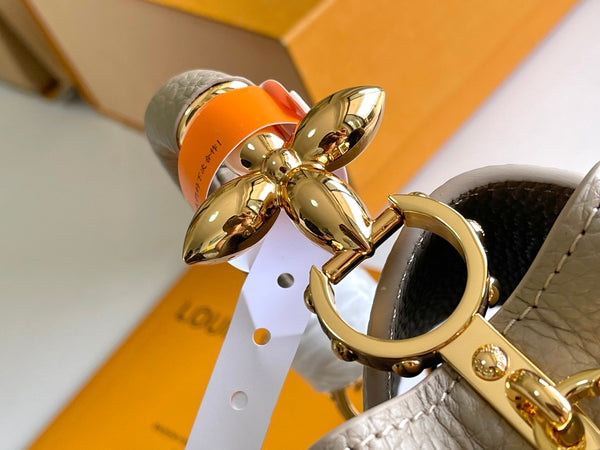 CAPUCINES MINI 21 DARK BEIGE TAURILLON GOLD HARDWARE