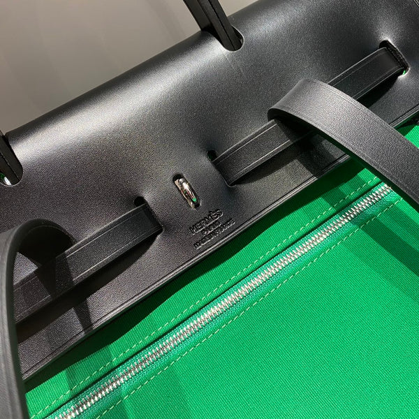 HERBAG A DOS ZIP RETOURNE BACKPACK 29 IN GREEN CANVAS AND BLACK CALFSKIN