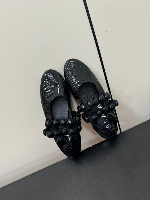 ALAIA SPHERE BALLET FLATS IN BLACK LAMBSKIN