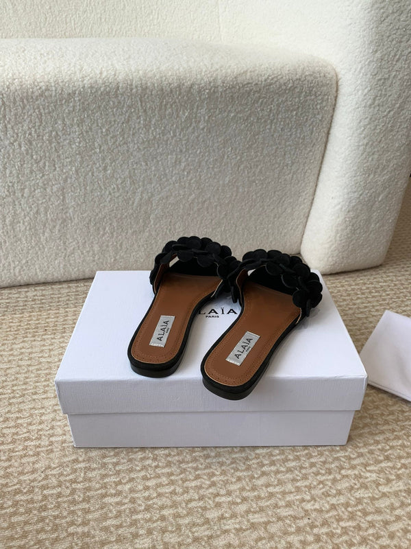 ALAIA FLAT MULE IN BLACK SUEDE