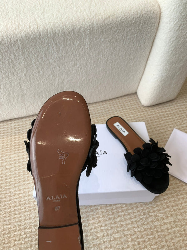 ALAIA FLAT MULE IN BLACK SUEDE