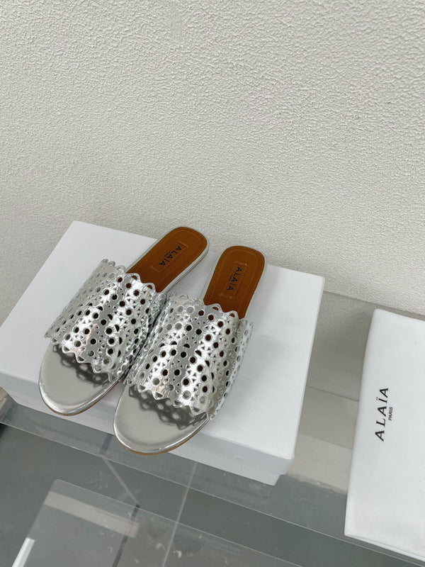 ALAIA VIENNE FLAT MULES IN SILVER LAMBSKIN