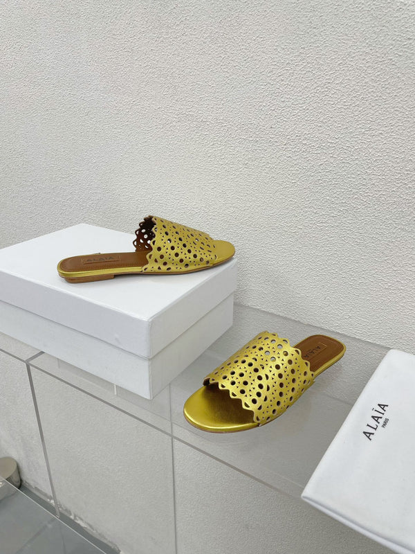 ALAIA VIENNE FLAT MULES IN GOLDEN LAMBSKIN