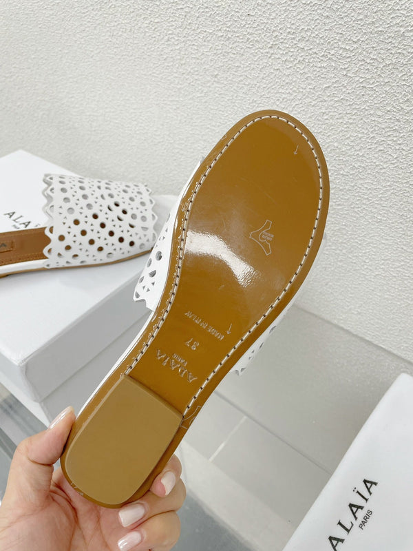 ALAIA VIENNE FLAT MULES IN WHITE LAMBSKIN