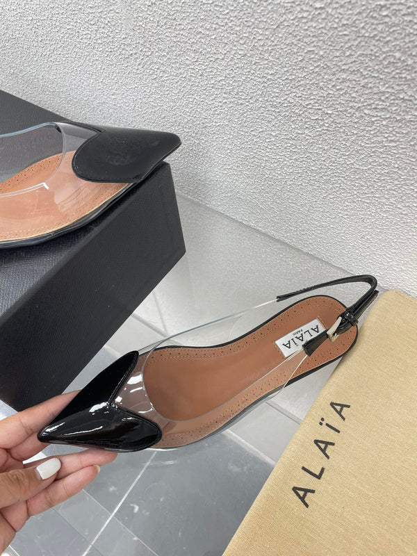 ALAIA LE COEUR FLAT SLINGBACKS IN BLACK PATENT LAMBSKIN