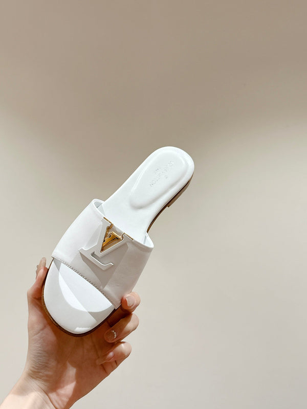lv capri flat mule white calfskin