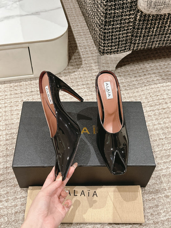 ALAIA SPIKE JEWEL MULES IN BLACK GLOSSY CALFSKIN