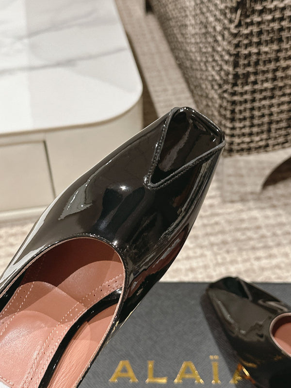 ALAIA SPIKE JEWEL MULES IN BLACK GLOSSY CALFSKIN