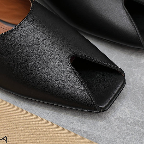 ALAIA FLAT MULE IN BLACK LAMBSKIN