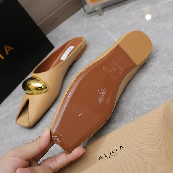 ALAIA FLAT MULE IN SEPIA TAN LAMBSKIN WITH GOLD HARDWARE