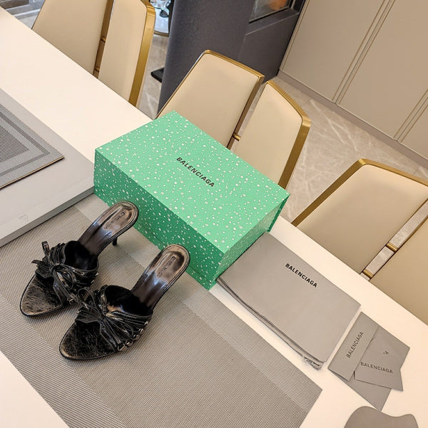 MULES ALTE IN PELLE DI MONTONE NERA CON FIOCCO