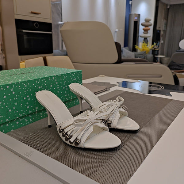 BOW-EMBELLISHED HIGH MULES IN WHITE SHEEPSKIN