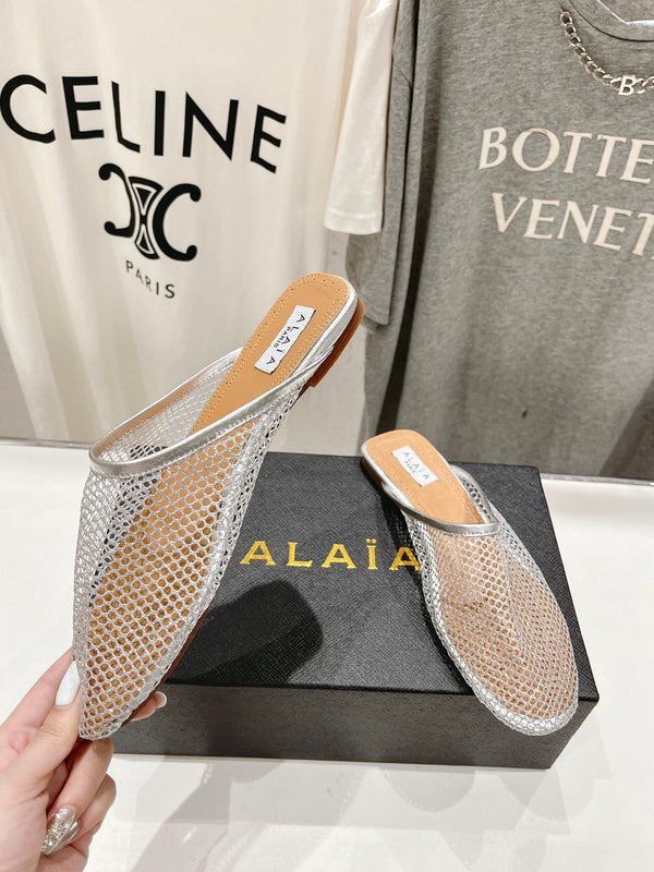 ALAIA FLAT MULES IN SILVER MESH FISHNET