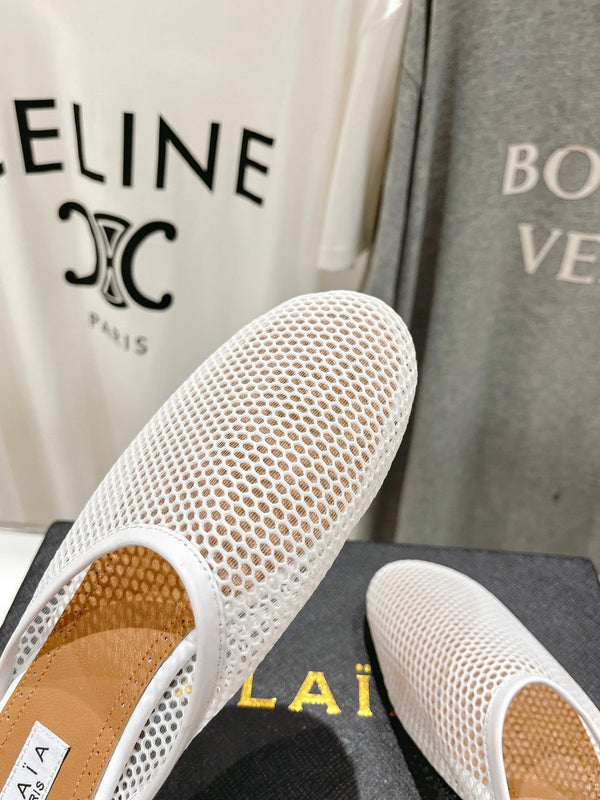 ALAIA FLAT MULES IN WHITE MESH FISHNET