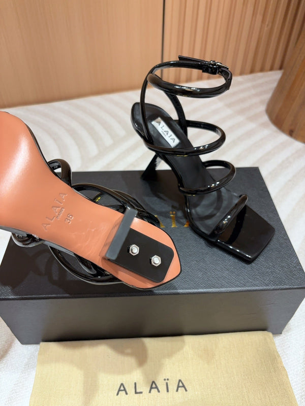 ALAIA THREE-STRAPS HIGH HEEL SANDALS IN BLACK PATENT LAMBSKIN