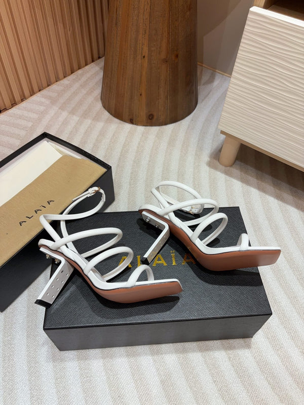 ALAIA THREE-STRAPS HIGH HEEL SANDALS IN WHITE PATENT LAMBSKIN