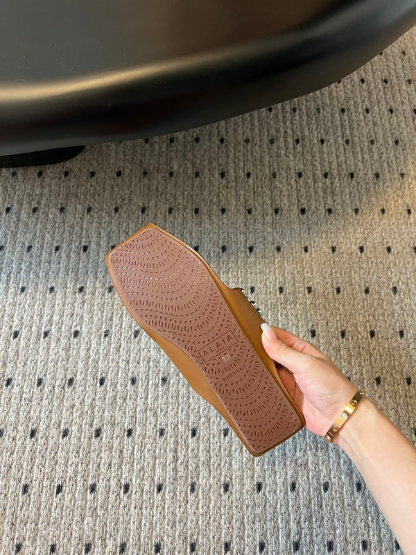 ALAIA FOLDED FLAT MULES WITH SPHERES ON COPPER BROWN CALFSKIN