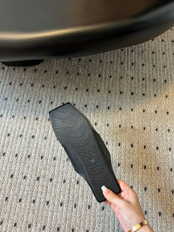 ALAIA FOLDED FLAT MULES WITH SPHERES ON BLACK CALFSKIN