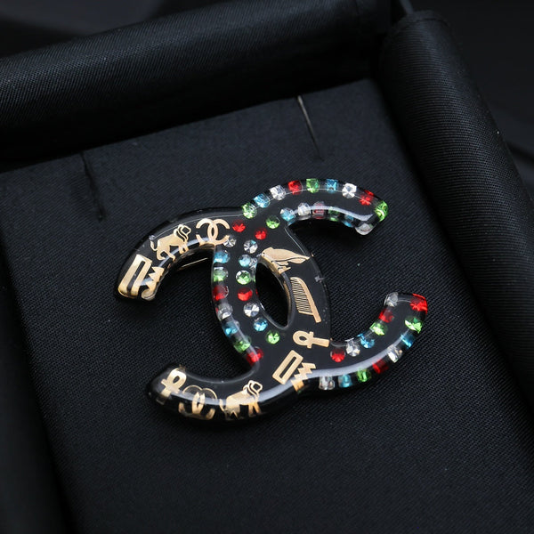 DOUBLE C BROOCH IN HAND-PAINTED ACRYLIC RESIN WITH COLORFUL STONE DESIGN