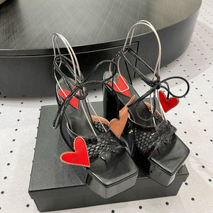 ALAIA BANQUET WEDGE SANDALS IN BLACK LAMBSKIN WITH RED HEART