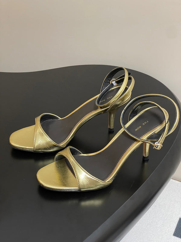 Sandali con tacco alto e cinturino The Row 25S 85 mm in pelle di vacchetta metallizzata nera e oro 286193